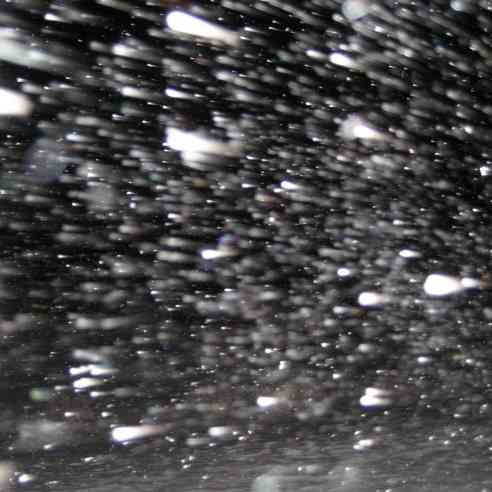 Snow falling on windshield